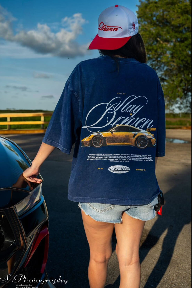 model wearing a blue tee outside