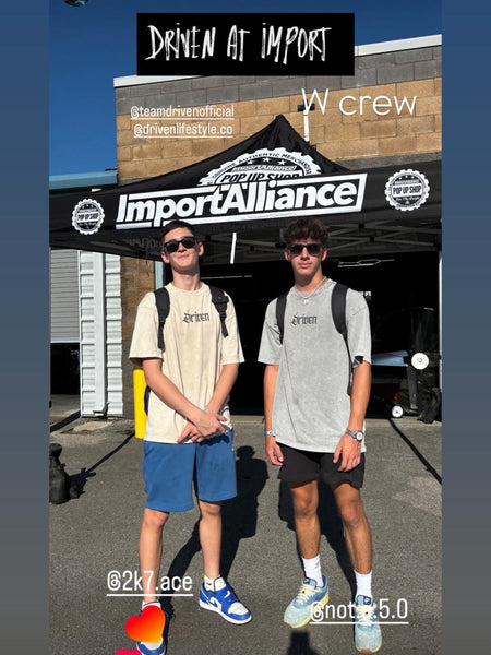 Two people standing in front of a branded backdrop with 'Import Alliance' and 'Driven at Import'.