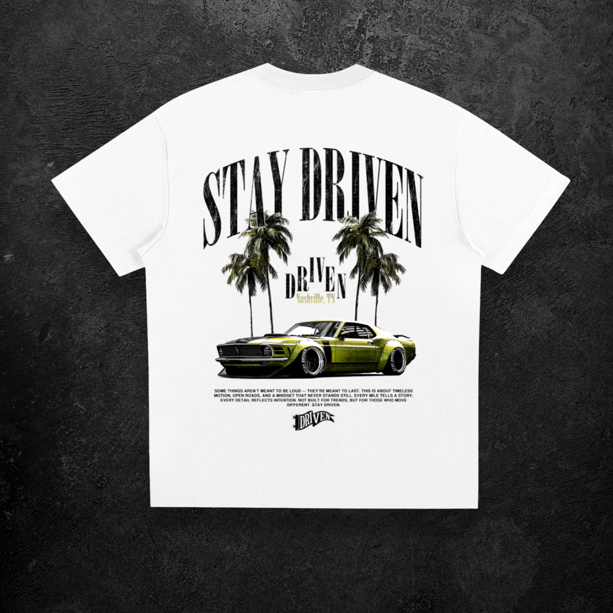White t-shirt with 'Stay Driven' graphic design featuring a car and palm trees on a dark background