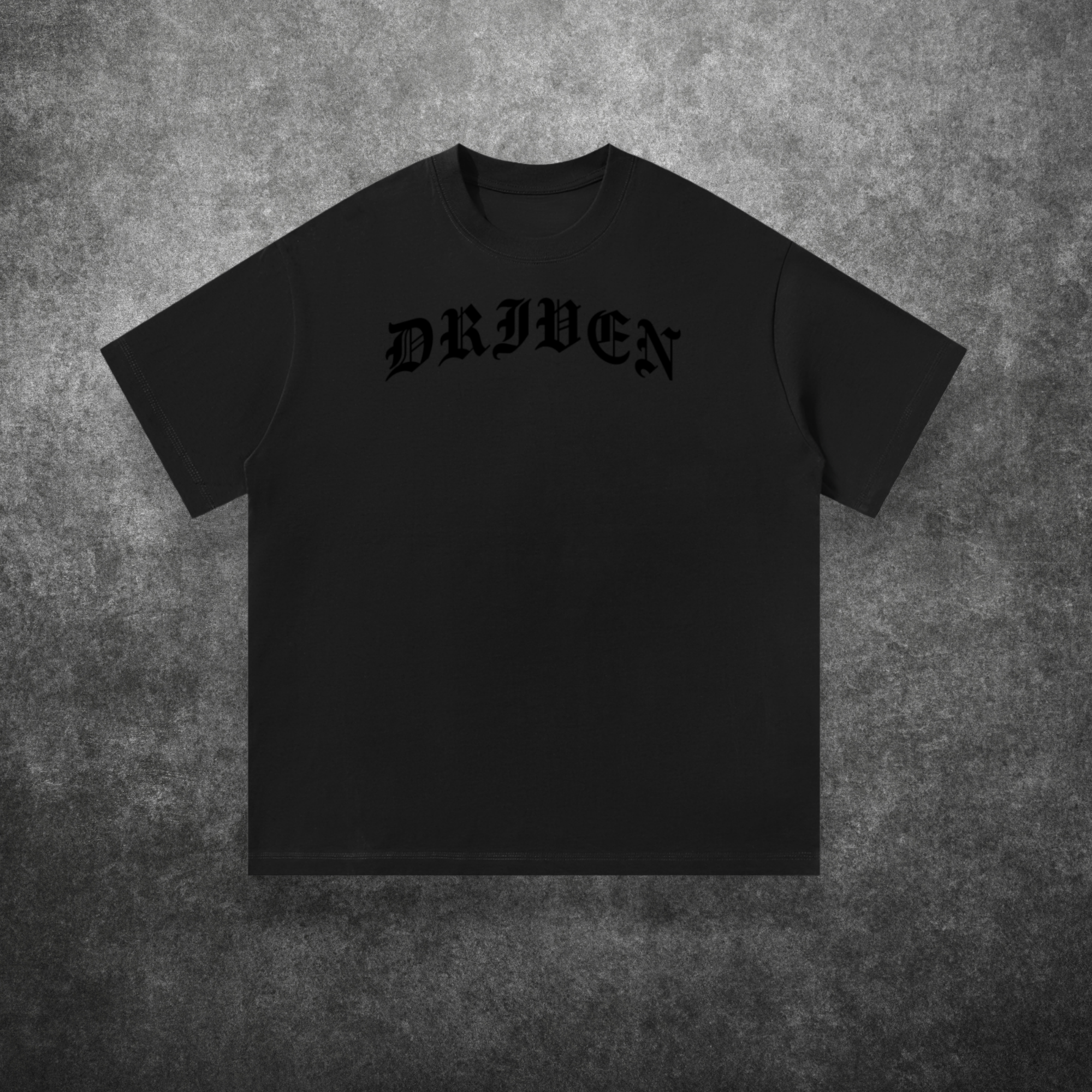 Black t-shirt with 'DRIVEN' text on a textured gray background