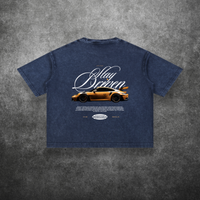 Blue t-shirt with car graphic and text on a textured gray background