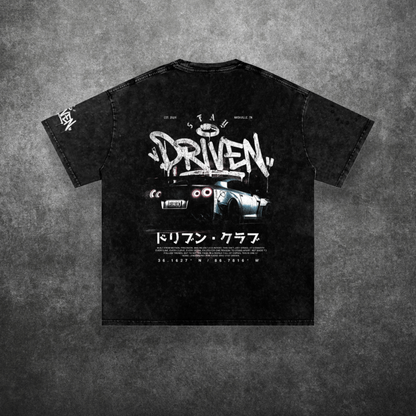 Black t-shirt with graphic design and text on a textured gray background