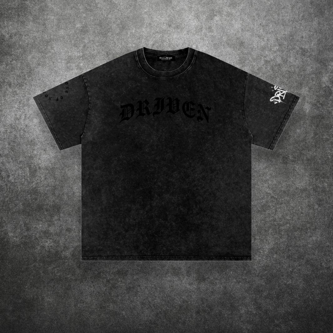 Black t-shirt with 'DRIVEN' text on a textured gray background